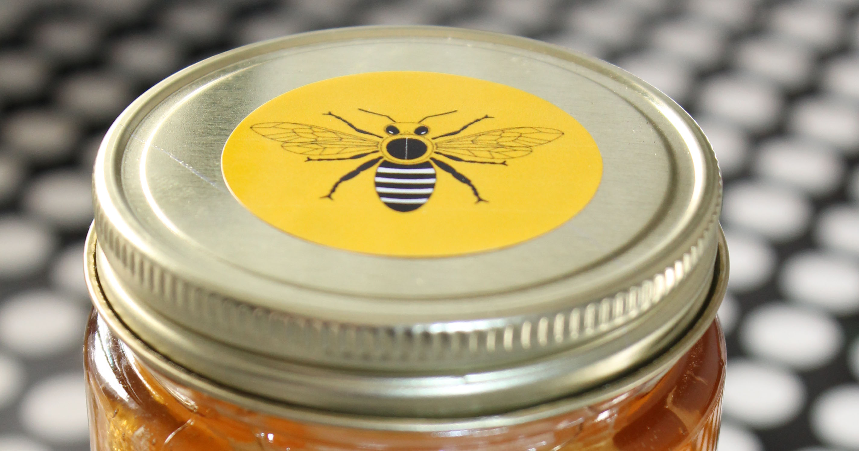 Honey jar with printable sticker attached to lid
