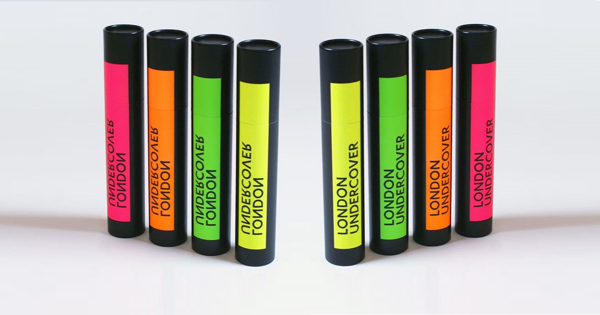 Black tubes to hold umbrellas with neon-coloured product labels